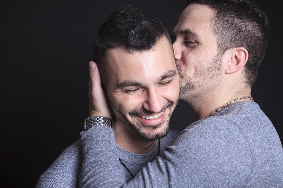 lgbtq gay men kiss on cheek