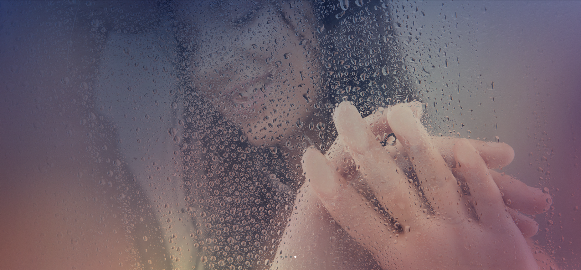 A couple holds hands in a steamy shower