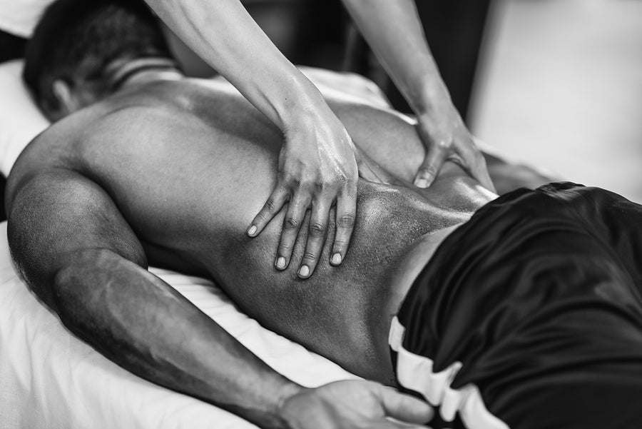 A man gives his partner a romantic massage