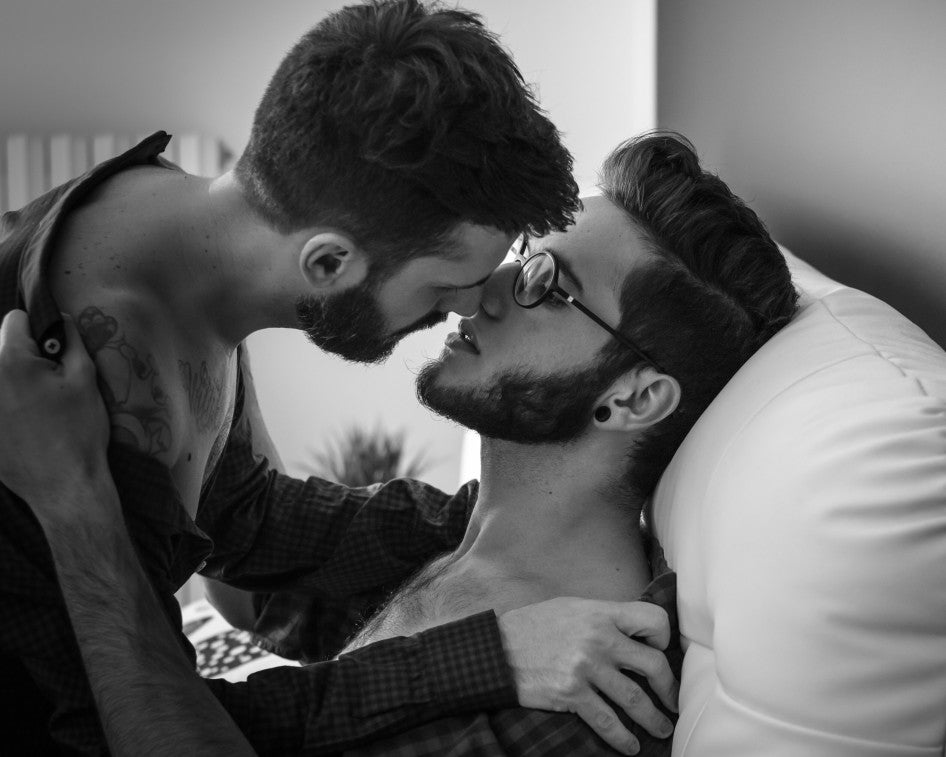 black and white photo of a male couple kissing