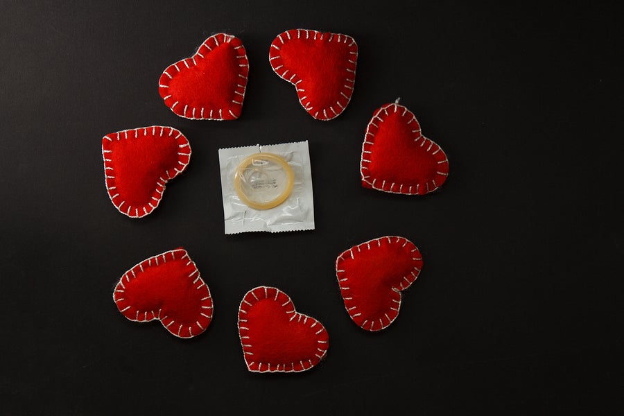 condom surrounded by felt hearts.